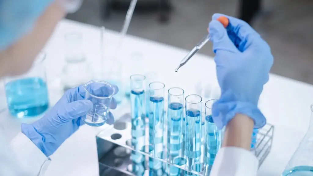 A fluid being dropped into a test tube