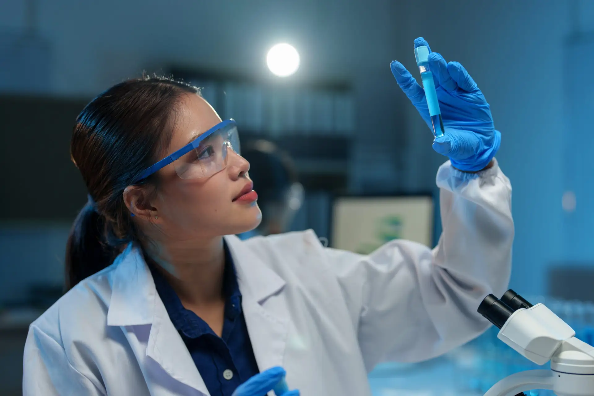 Female scientist holds a test tube with fluid